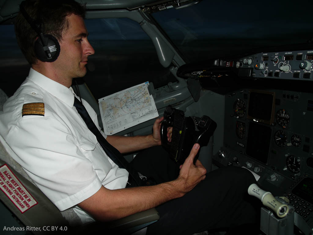 a pilot in a cockpit, flying