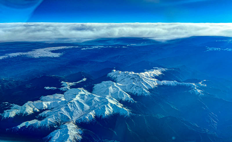 snow-capped mountains below