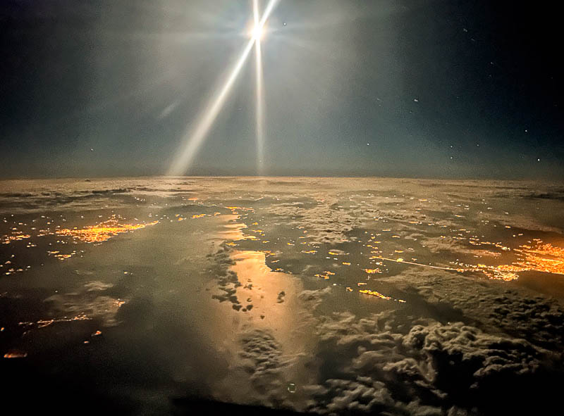 clouds below with an orange glow